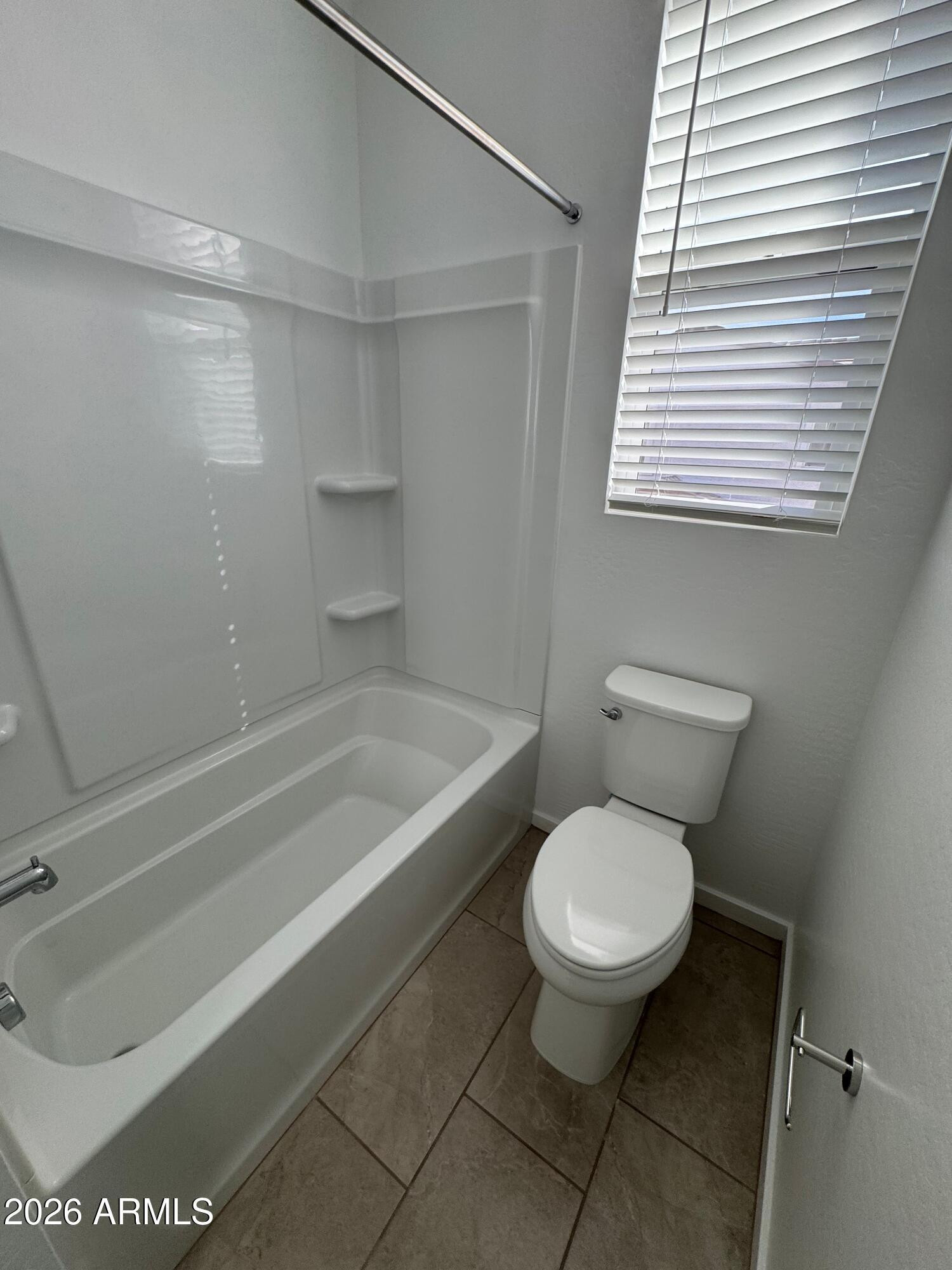 2438 West Rowel Road Phoenix, AZ 85085 - Photo 25 of 30 a bathroom with a toilet and a bathtub