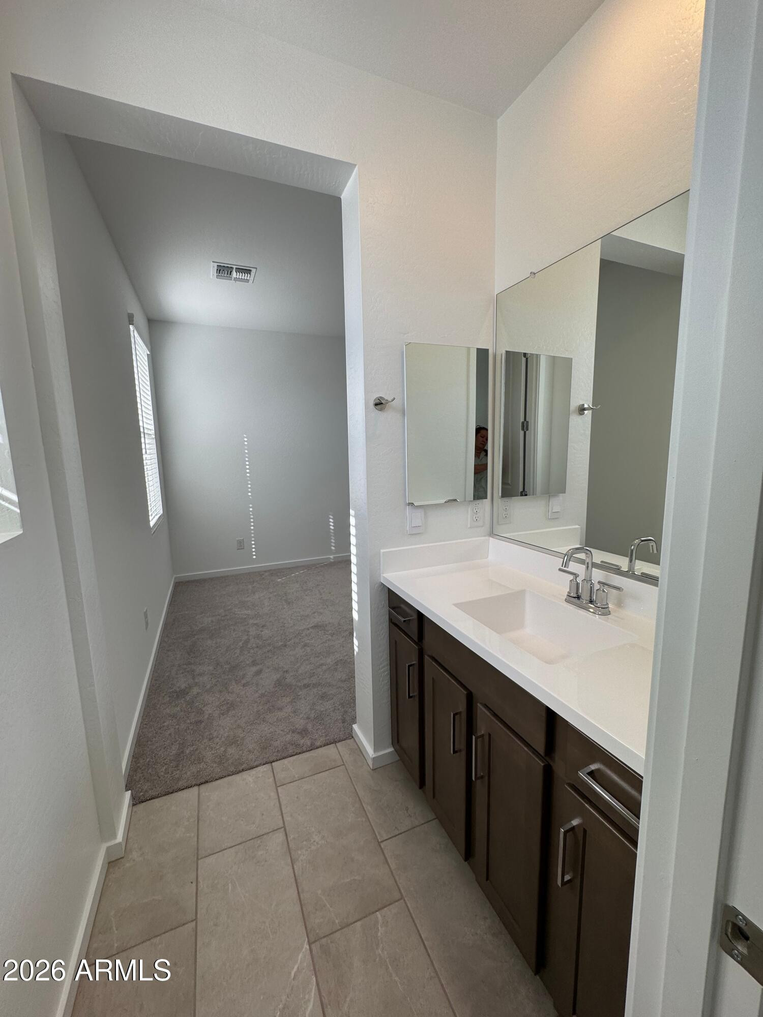 2438 West Rowel Road Phoenix, AZ 85085 - Photo 27 of 30 a bathroom with a sink and a mirror