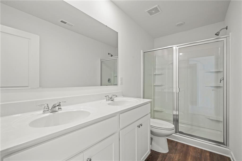 155 Star Court Pendergrass, GA 30567 - Photo 16 of 34 a bathroom with a double vanity sink toilet and shower