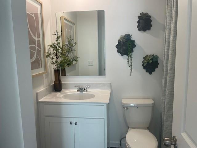 155 Star Court Pendergrass, GA 30567 - Photo 21 of 34 a bathroom with a toilet sink and mirror