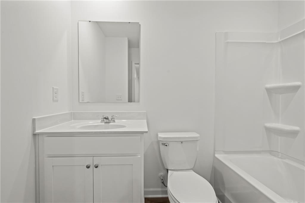 155 Star Court Pendergrass, GA 30567 - Photo 22 of 34 a bathroom with a toilet sink and mirror
