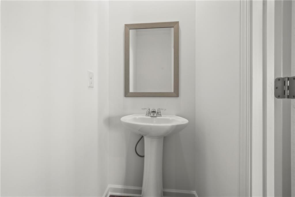 155 Star Court Pendergrass, GA 30567 - Photo 30 of 34 a bathroom with a sink a mirror and a