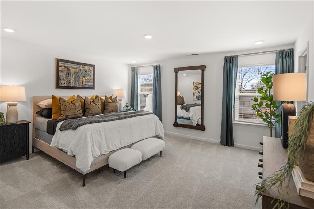 155 Star Court Pendergrass, GA 30567 - Photo 5 of 34 a spacious bedroom with a bed and a couch