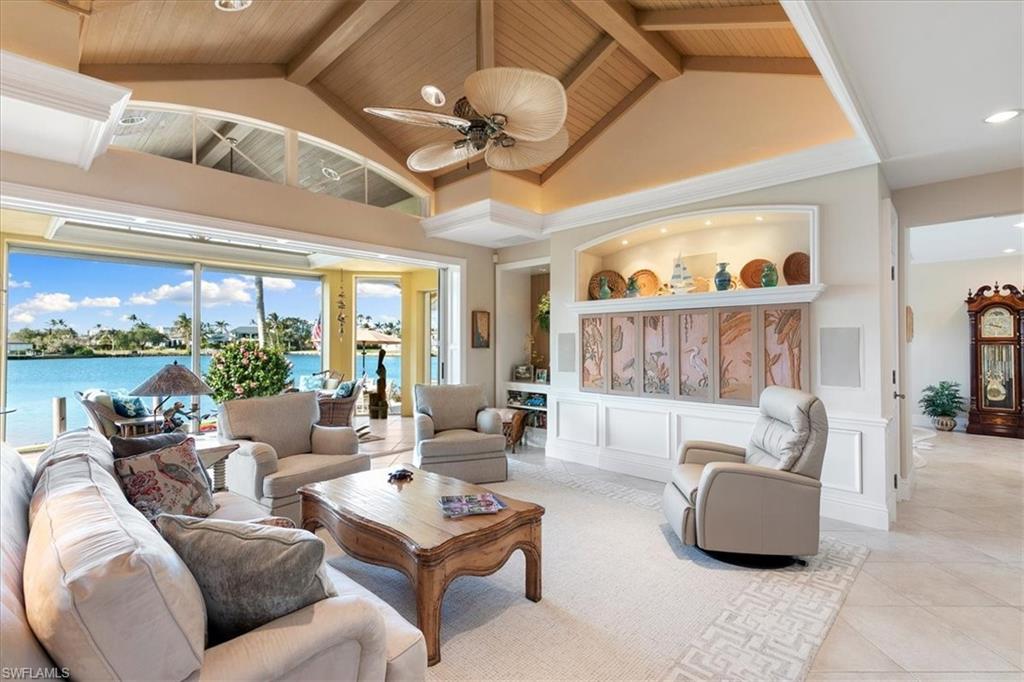 400 Springline Drive Naples, FL 34102 - Photo 14 of 32 a living room with furniture and a large window