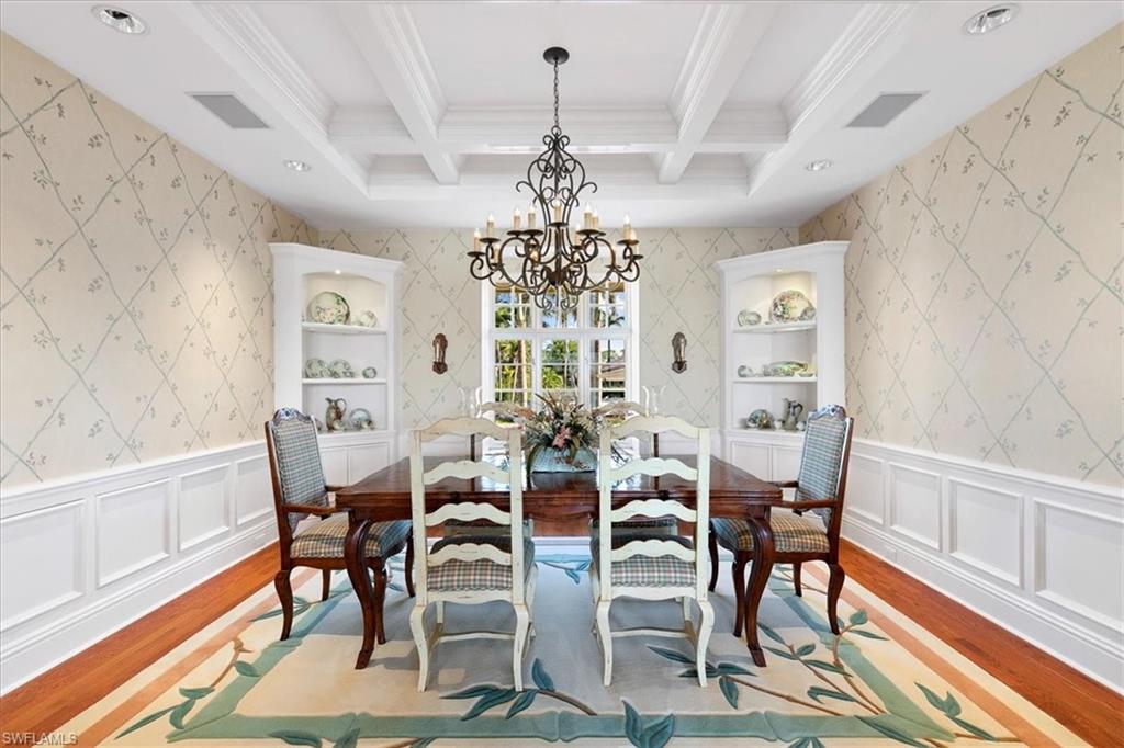 400 Springline Drive Naples, FL 34102 - Photo 15 of 32 a view of a dining room with furniture window and wooden floor