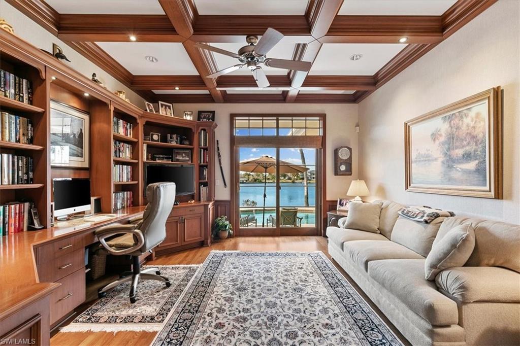400 Springline Drive Naples, FL 34102 - Photo 16 of 32 a living room with furniture a rug and a large window