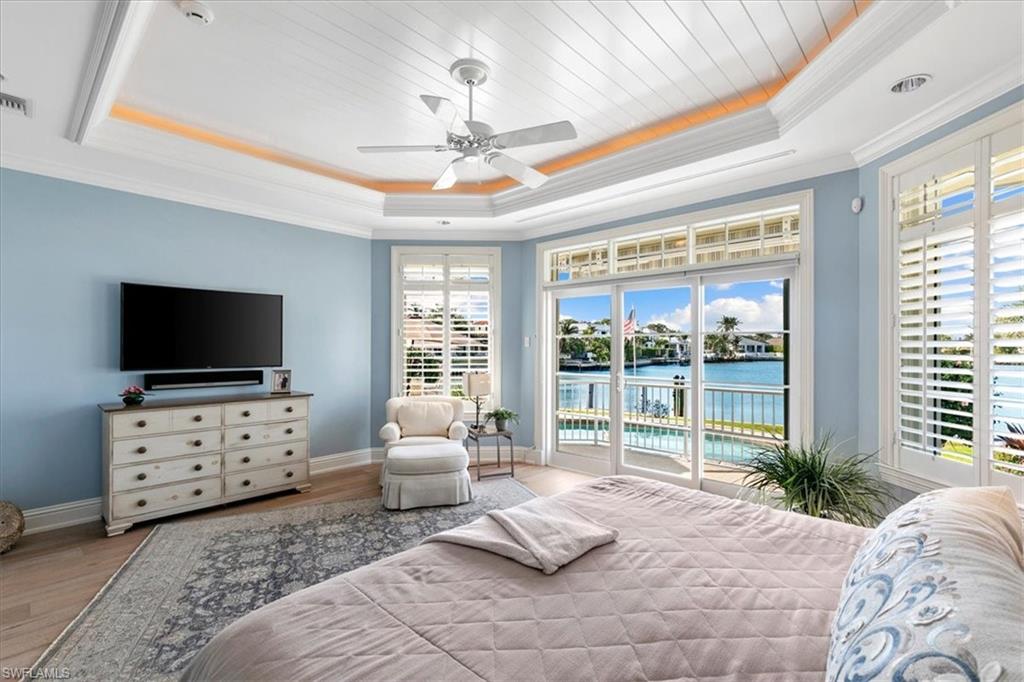 400 Springline Drive Naples, FL 34102 - Photo 17 of 32 a bedroom with furniture and flat screen tv