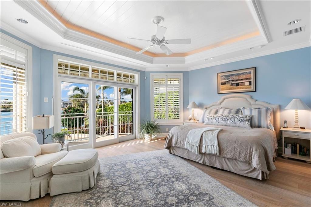 400 Springline Drive Naples, FL 34102 - Photo 18 of 32 a spacious bedroom with a bed and glass window