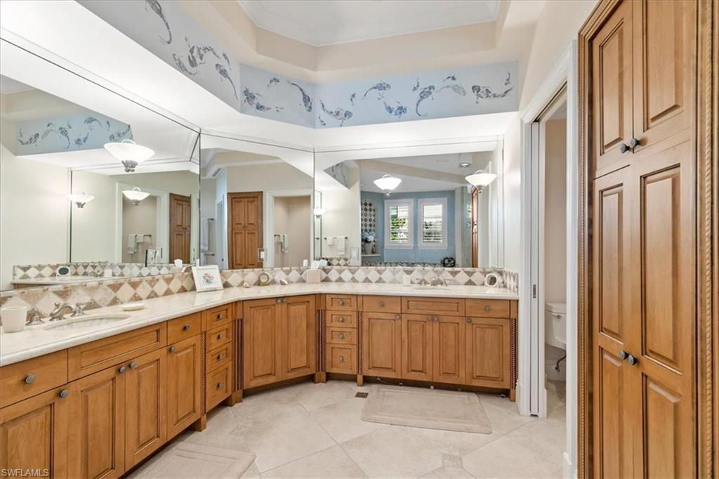 400 Springline Drive Naples, FL 34102 - Photo 20 of 32 a bathroom with a granite countertop sink mirror and bathtub