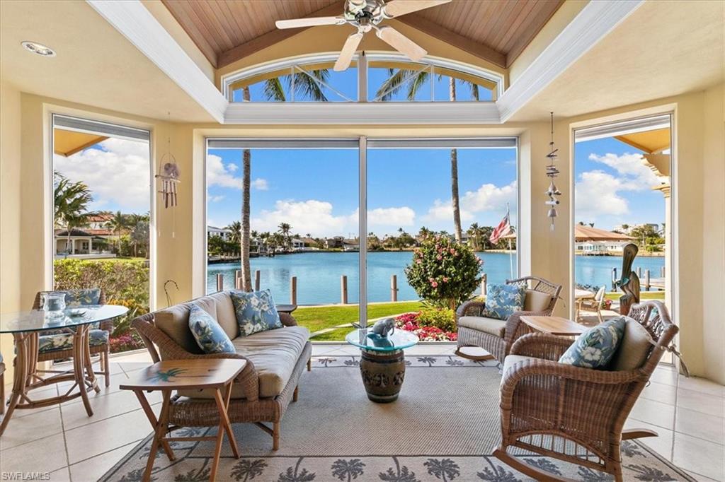 400 Springline Drive Naples, FL 34102 - Photo 21 of 32 a living room with furniture and a large window