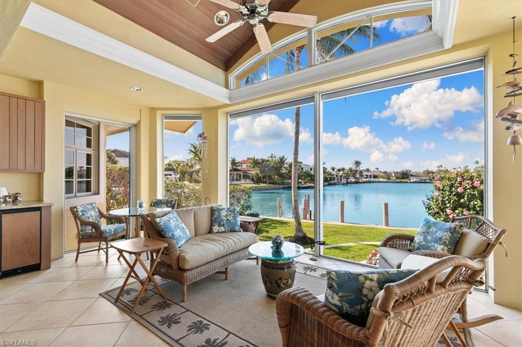 400 Springline Drive Naples, FL 34102 - Photo 22 of 32 a living room with furniture and a large window