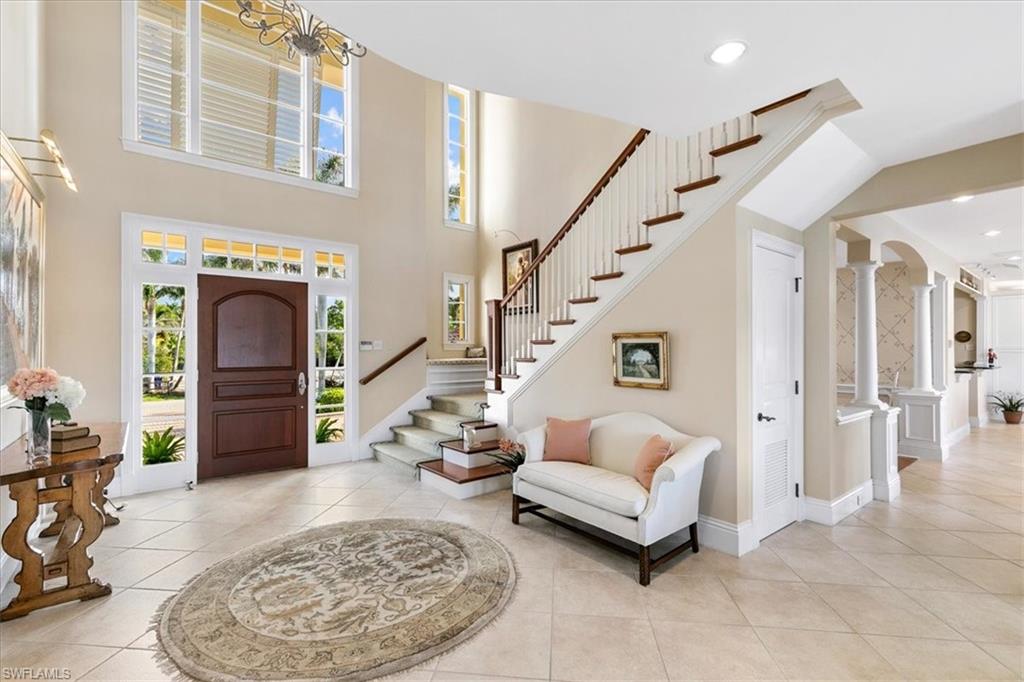 400 Springline Drive Naples, FL 34102 - Photo 24 of 32 a living room with furniture and a fireplace