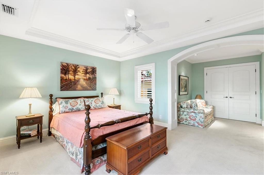 400 Springline Drive Naples, FL 34102 - Photo 29 of 32 a bedroom with a bed and a chandelier