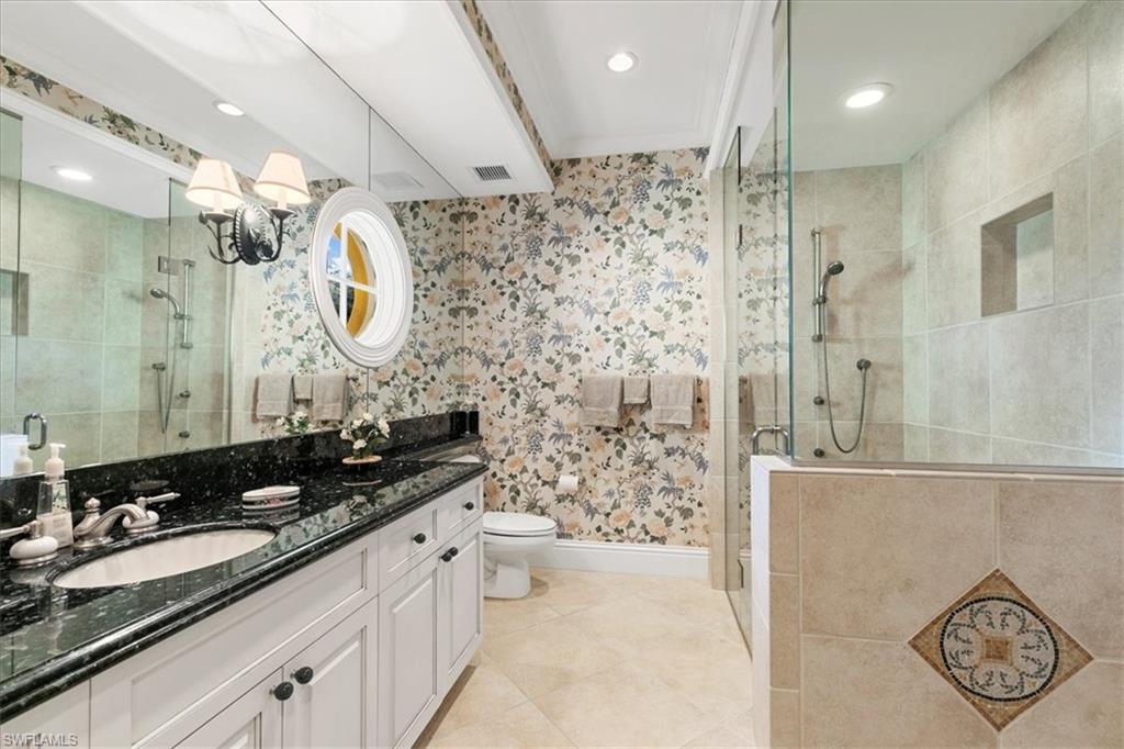 400 Springline Drive Naples, FL 34102 - Photo 30 of 32 a bathroom with a double vanity sink mirror and shower