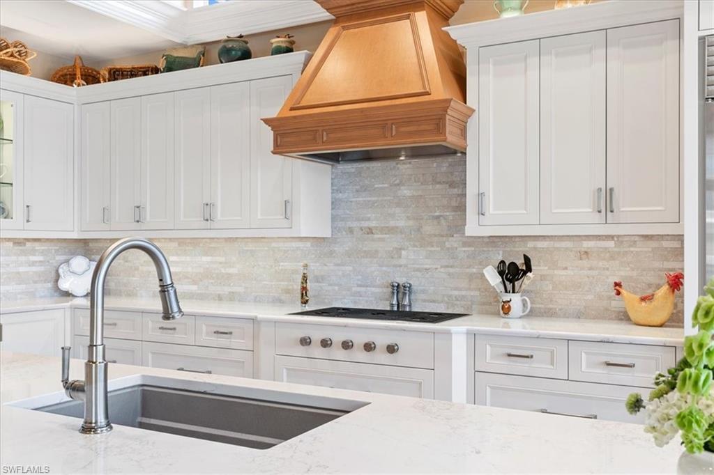 400 Springline Drive Naples, FL 34102 - Photo 9 of 32 a kitchen with granite countertop white cabinets and white appliances