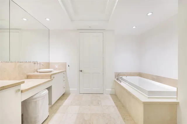 a bathroom with a sink a vanity and a tub