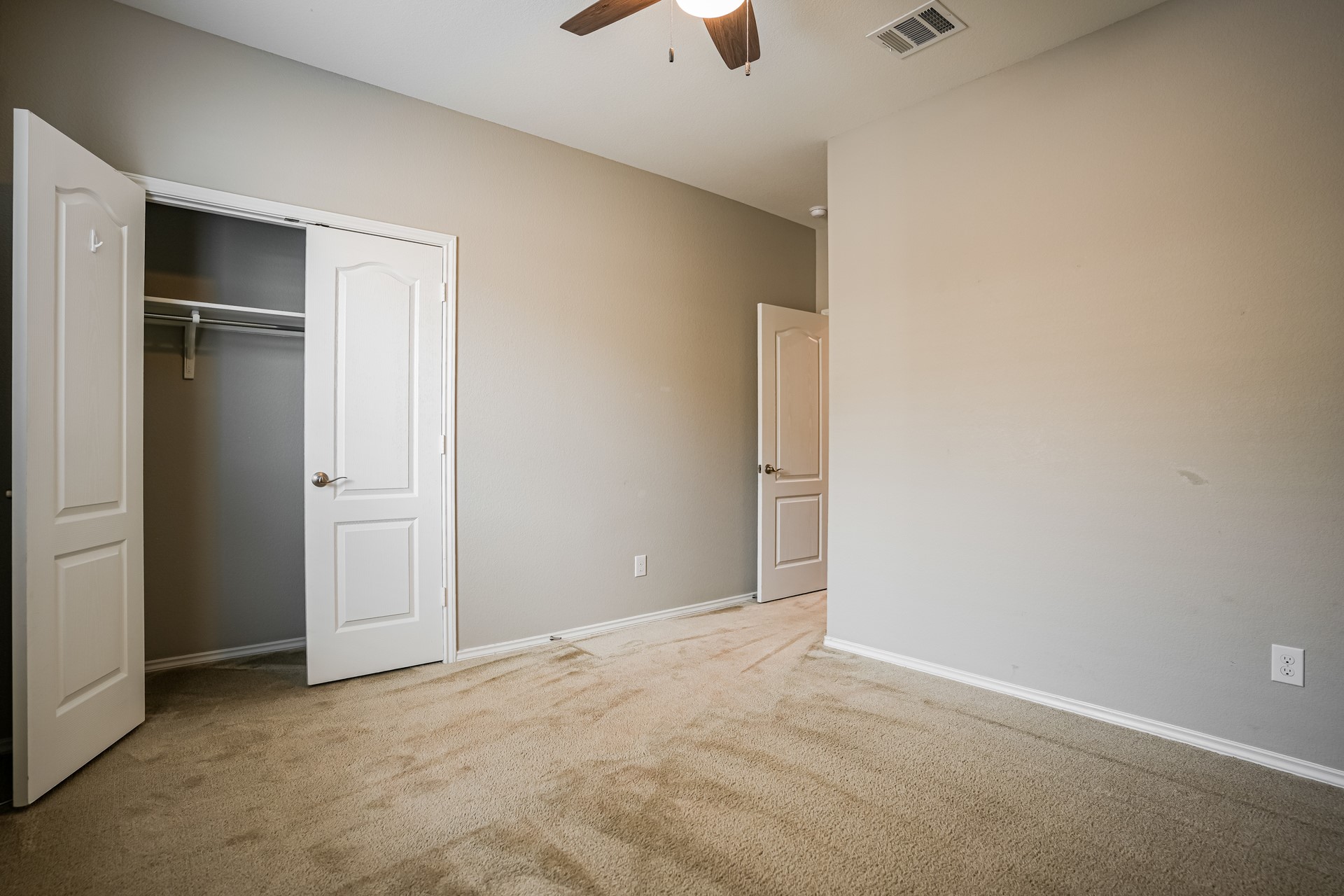 17313 Crazy Arm Road, Unit 233 Round Rock, TX 78664 - Photo 13 of 20 Bedroom 2 with ceiling fan and carpet