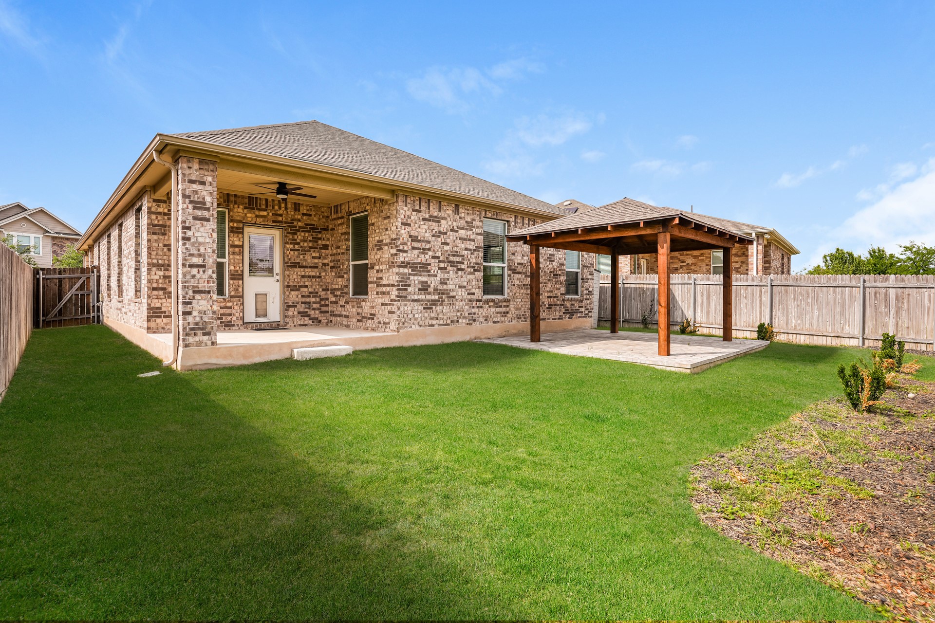 17313 Crazy Arm Road, Unit 233 Round Rock, TX 78664 - Photo 19 of 20 Backyard with two covered patios and fenced backyard