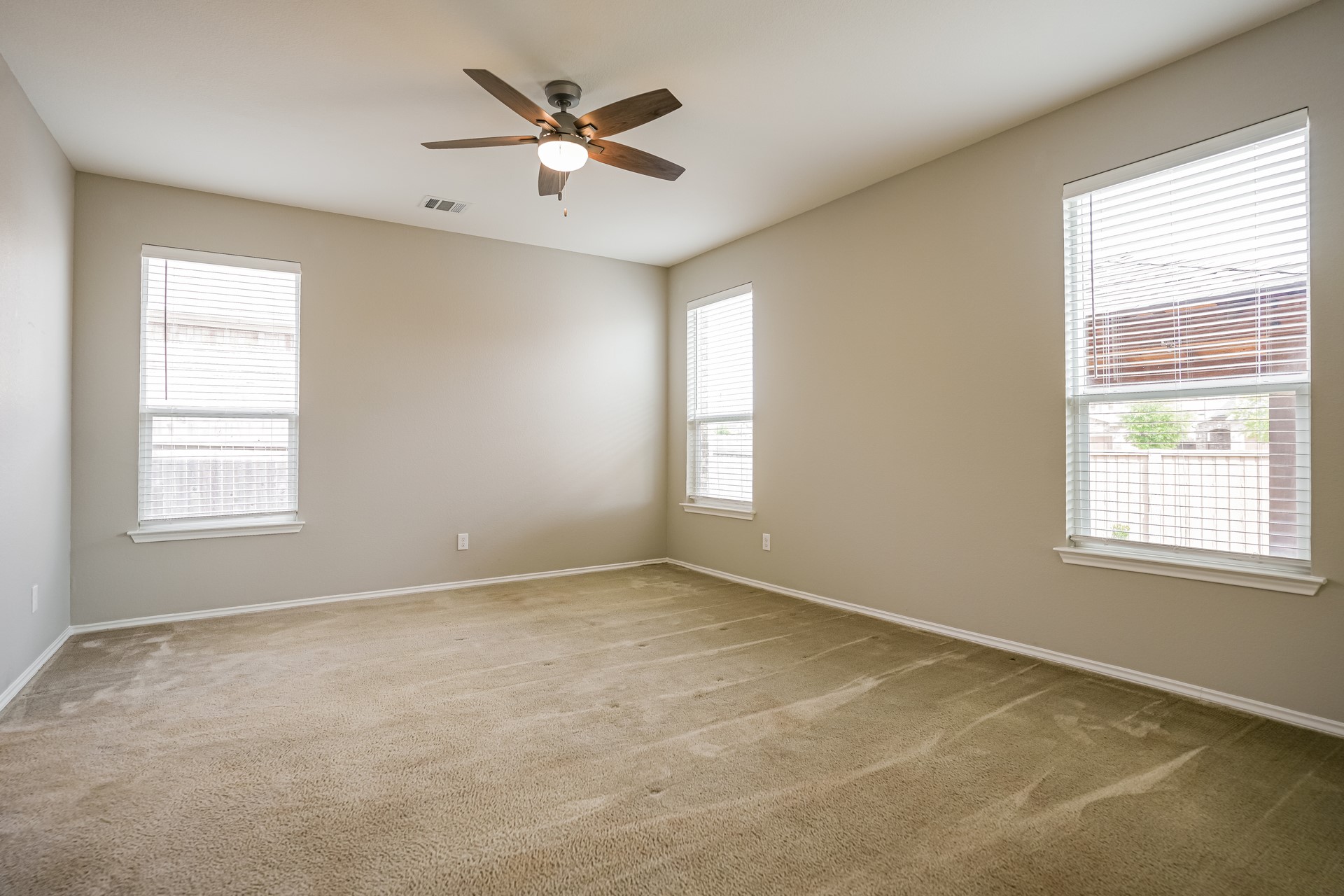 17313 Crazy Arm Road, Unit 233 Round Rock, TX 78664 - Photo 7 of 20 Primary bedroom with carpet, ceiling fan and natural light.