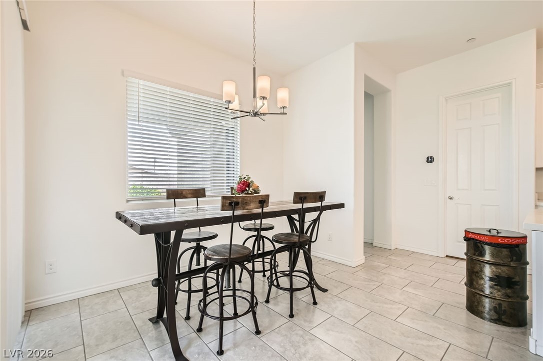 498 Pebble Run Avenue Henderson, NV 89011 - Photo 6 of 47 This naturally illuminated dining area features durable tile flooring, creating a comfortable space for meals and gatherings.