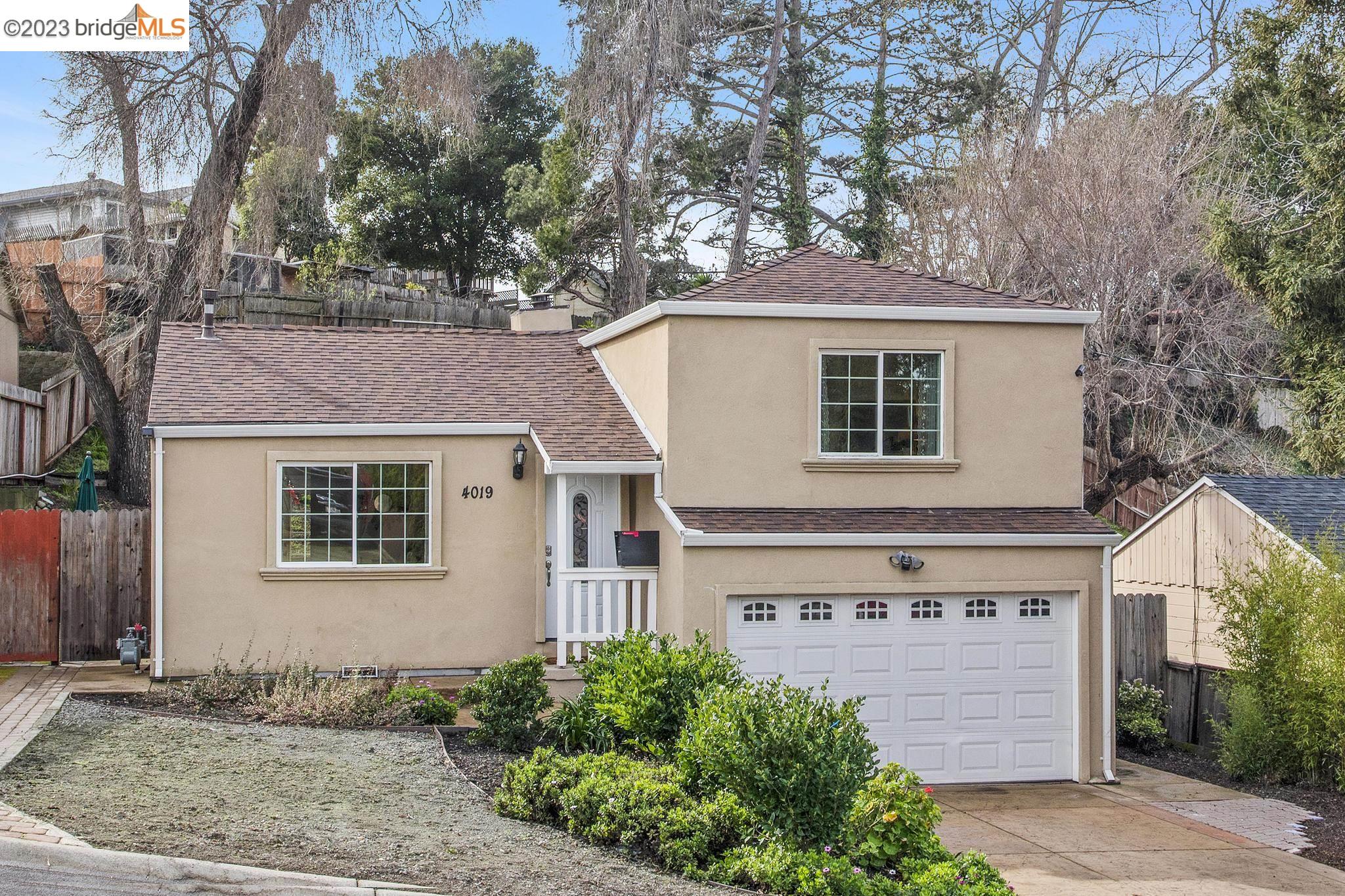 4019 La Colina Road El Sobrante, CA 94803 - Photo 1 of 1 a front view of a house with a yard and garage