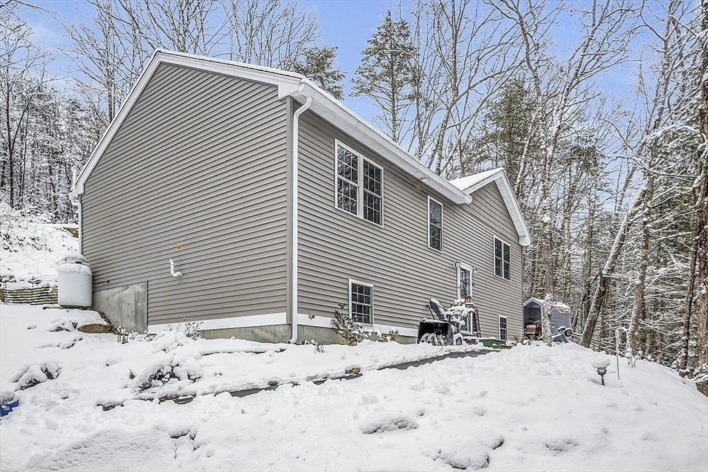 667 Brickyard Road Athol, MA 01331 - Photo 1 of 32 a view of a house with a yard covered in snow
