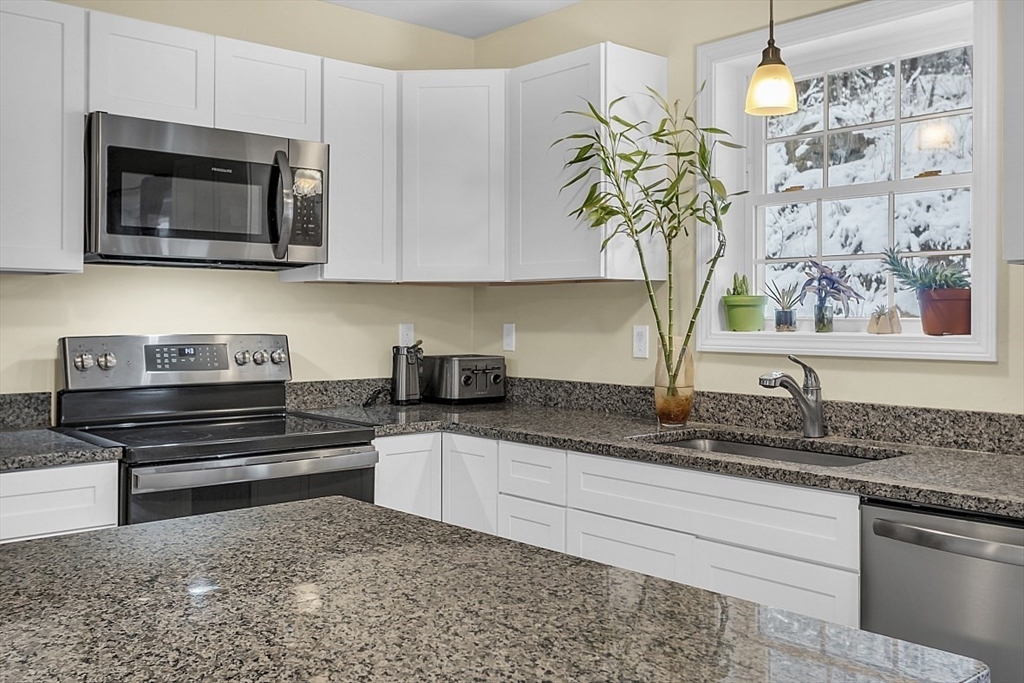 667 Brickyard Road Athol, MA 01331 - Photo 13 of 32 a kitchen with stainless steel appliances granite countertop a sink a stove and microwave