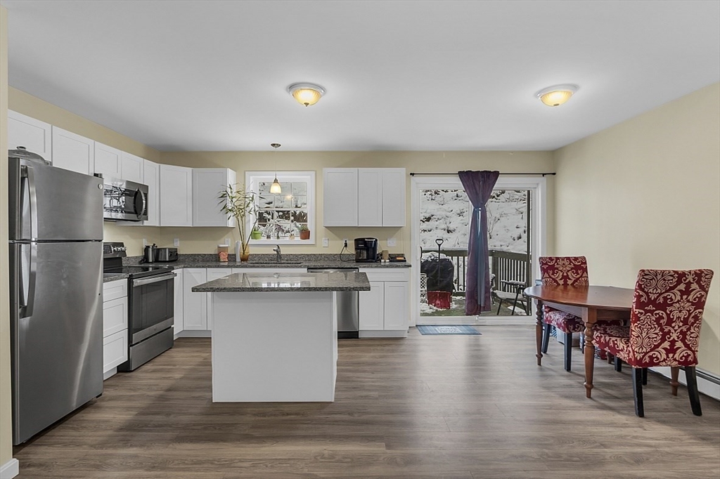 667 Brickyard Road Athol, MA 01331 - Photo 15 of 32 a kitchen with stainless steel appliances a refrigerator a sink dishwasher a stove and white cabinets with wooden floor