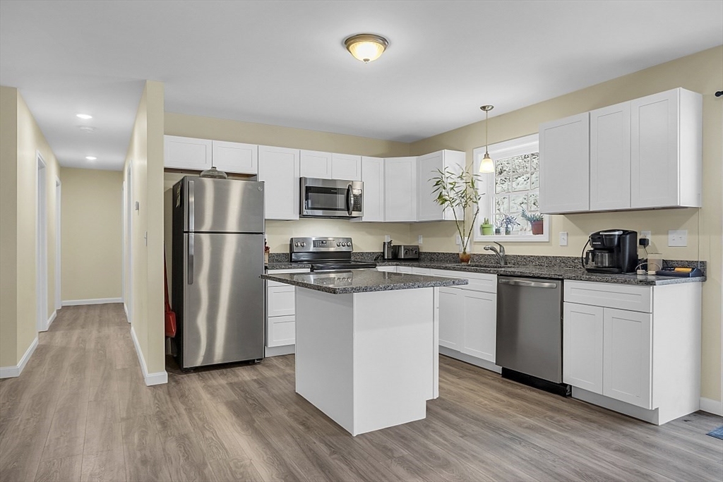667 Brickyard Road Athol, MA 01331 - Photo 16 of 32 a kitchen with a refrigerator a stove top oven and white cabinets