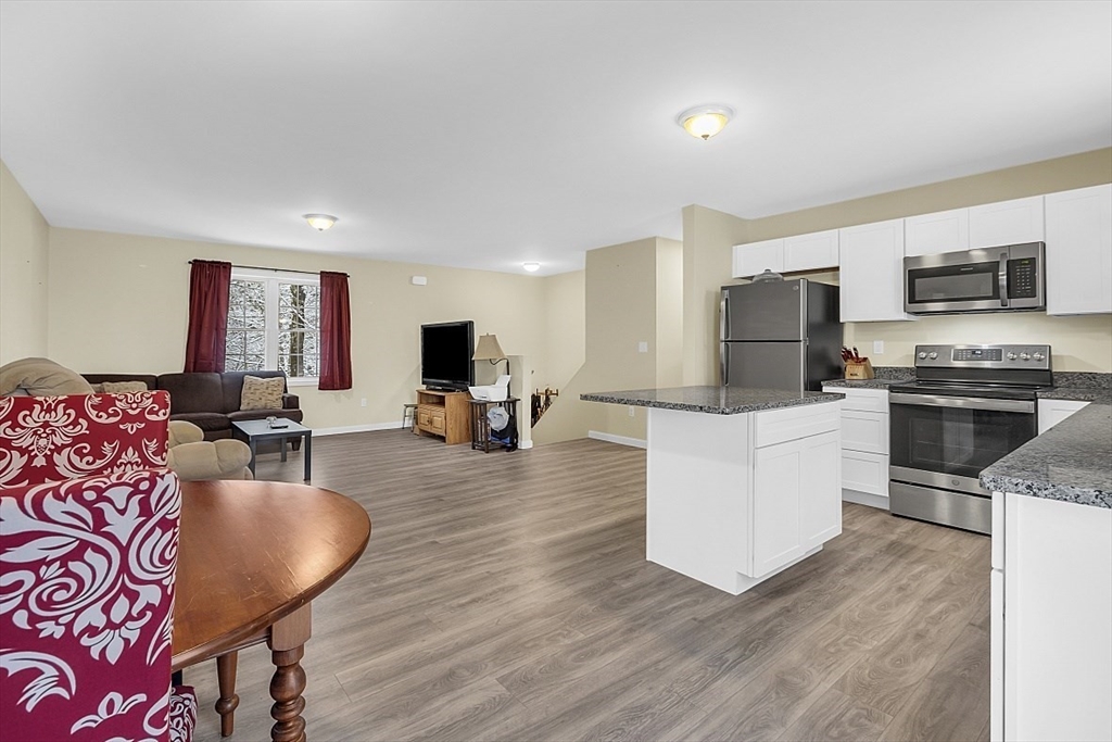 667 Brickyard Road Athol, MA 01331 - Photo 21 of 32 a living room with stainless steel appliances furniture and a kitchen view
