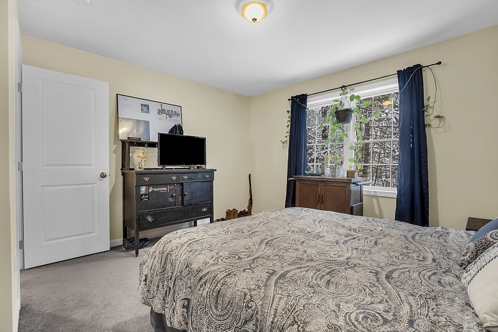 667 Brickyard Road Athol, MA 01331 - Photo 25 of 32 a bedroom with a bed and a television