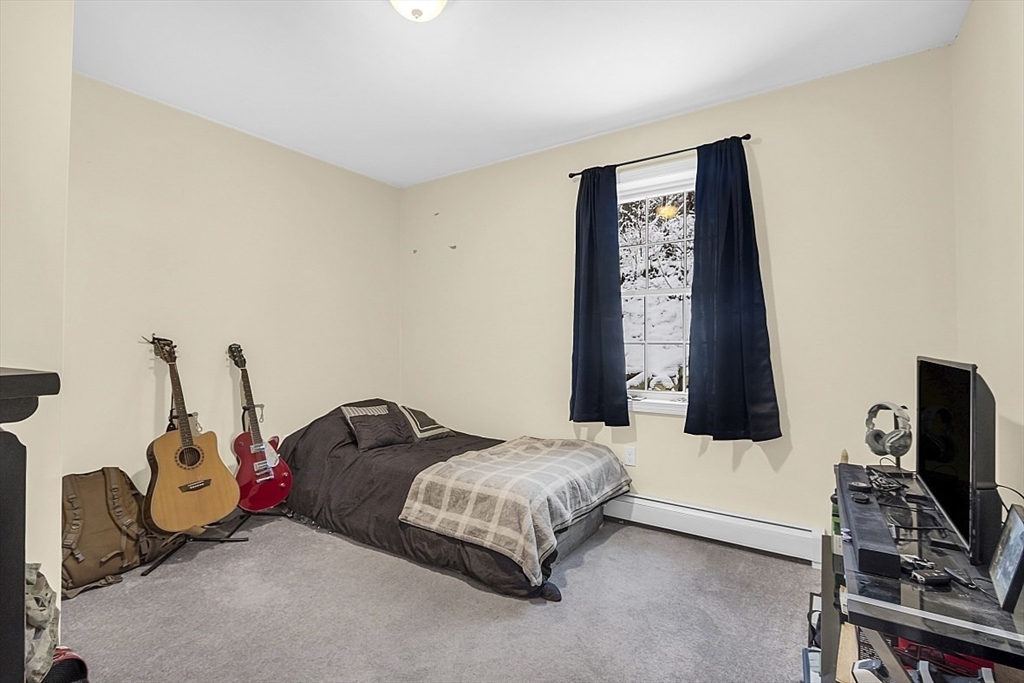 667 Brickyard Road Athol, MA 01331 - Photo 27 of 32 a bedroom with a bed and a flat tv screen on the dresser