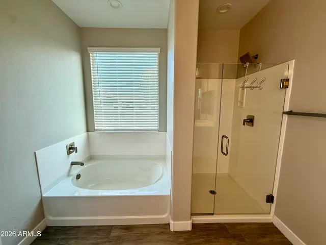a bathroom with a shower and a bath tub