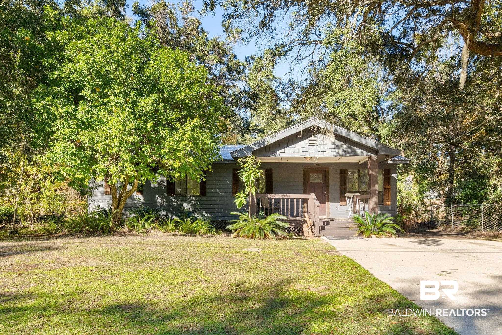 6233 Ponder Road Fairhope, AL 36532 - Photo 1 of 20 View of front of house with covered porch and a front yard