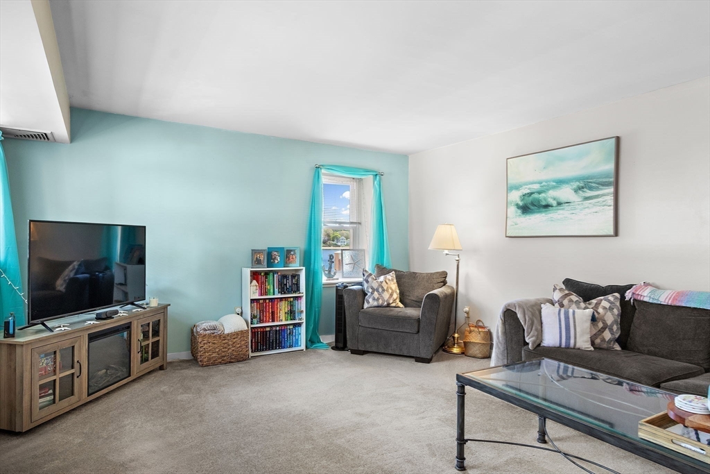 45 Main Street, Unit 21 Wareham, MA 02571 - Photo 11 of 29 a living room with furniture and a flat screen tv