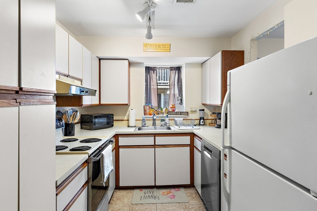 45 Main Street, Unit 21 Wareham, MA 02571 - Photo 12 of 29 a kitchen with a sink stove and refrigerator