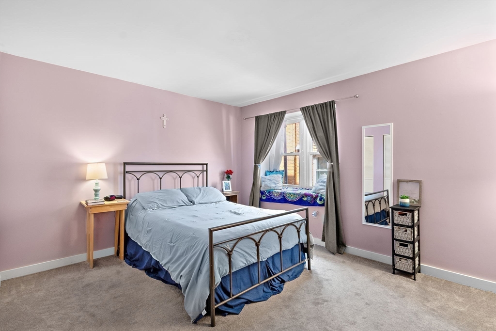 45 Main Street, Unit 21 Wareham, MA 02571 - Photo 16 of 29 a bedroom with a bed table and a window