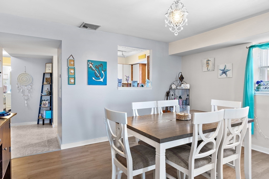 45 Main Street, Unit 21 Wareham, MA 02571 - Photo 6 of 29 a view of a dining room with furniture and chandelier
