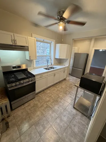 a kitchen with stainless steel appliances a stove a sink and a refrigerator