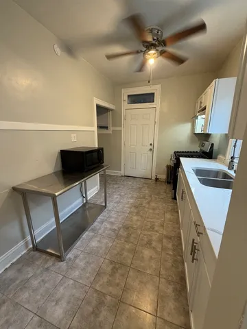a living room with a sink furniture and a stove