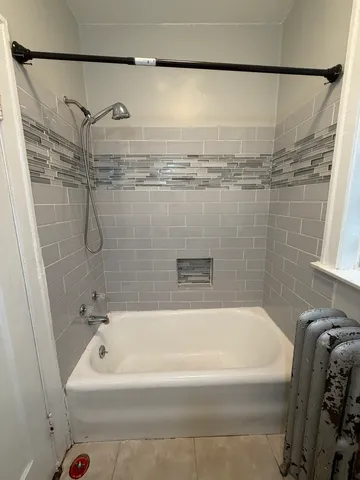 a bathroom with a bathtub and shower