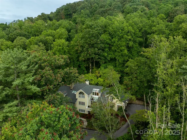 an aerial view of a house with yard