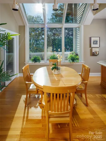 a dining room with furniture and wooden floor