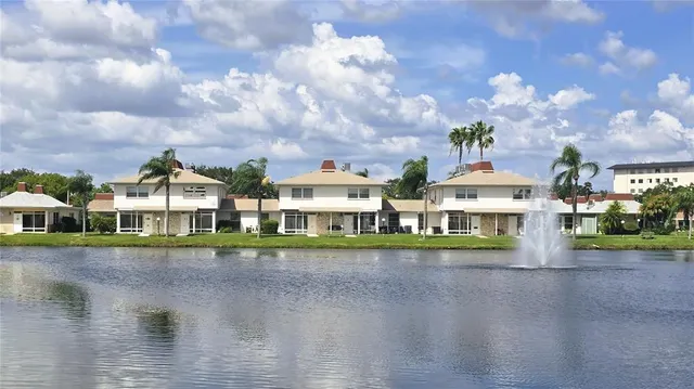 a front view of a house with swimming pool and a yard