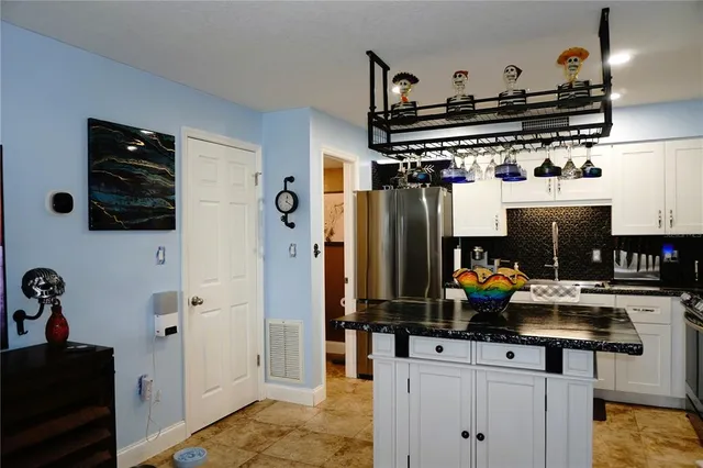a kitchen with stainless steel appliances a stove and a refrigerator