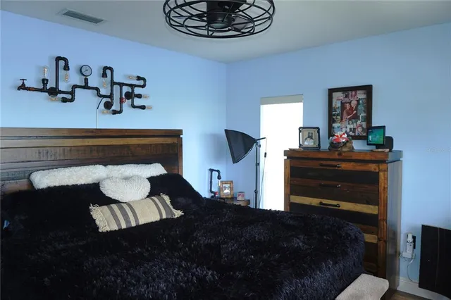 a bedroom with a bed and window