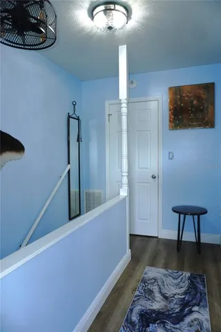 a living room with furniture and a lamp