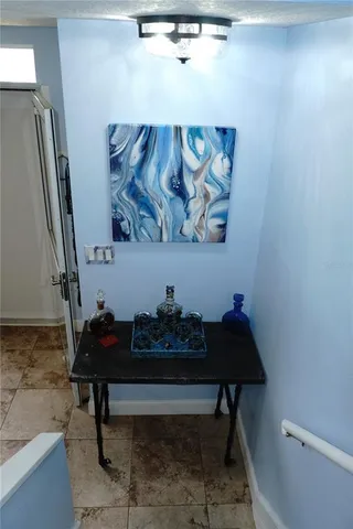 a bench sitting in a field next to a window