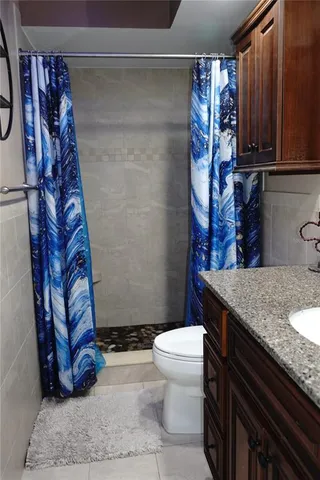 a bathroom with a granite countertop bathtub and sink