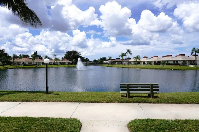 a view of a lake with houses in the back